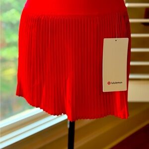 NWT LULULEMON red pleated tennis skirt with built in shorts.